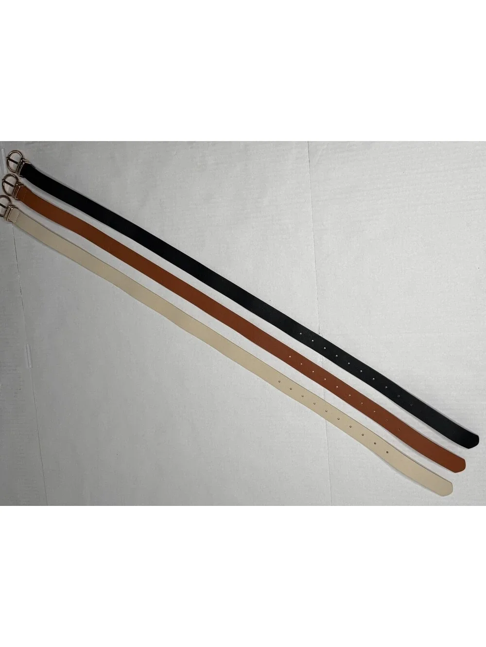 Women's Set of 3 Gold Buckle Accented Belts in Black, Brown and Cream.